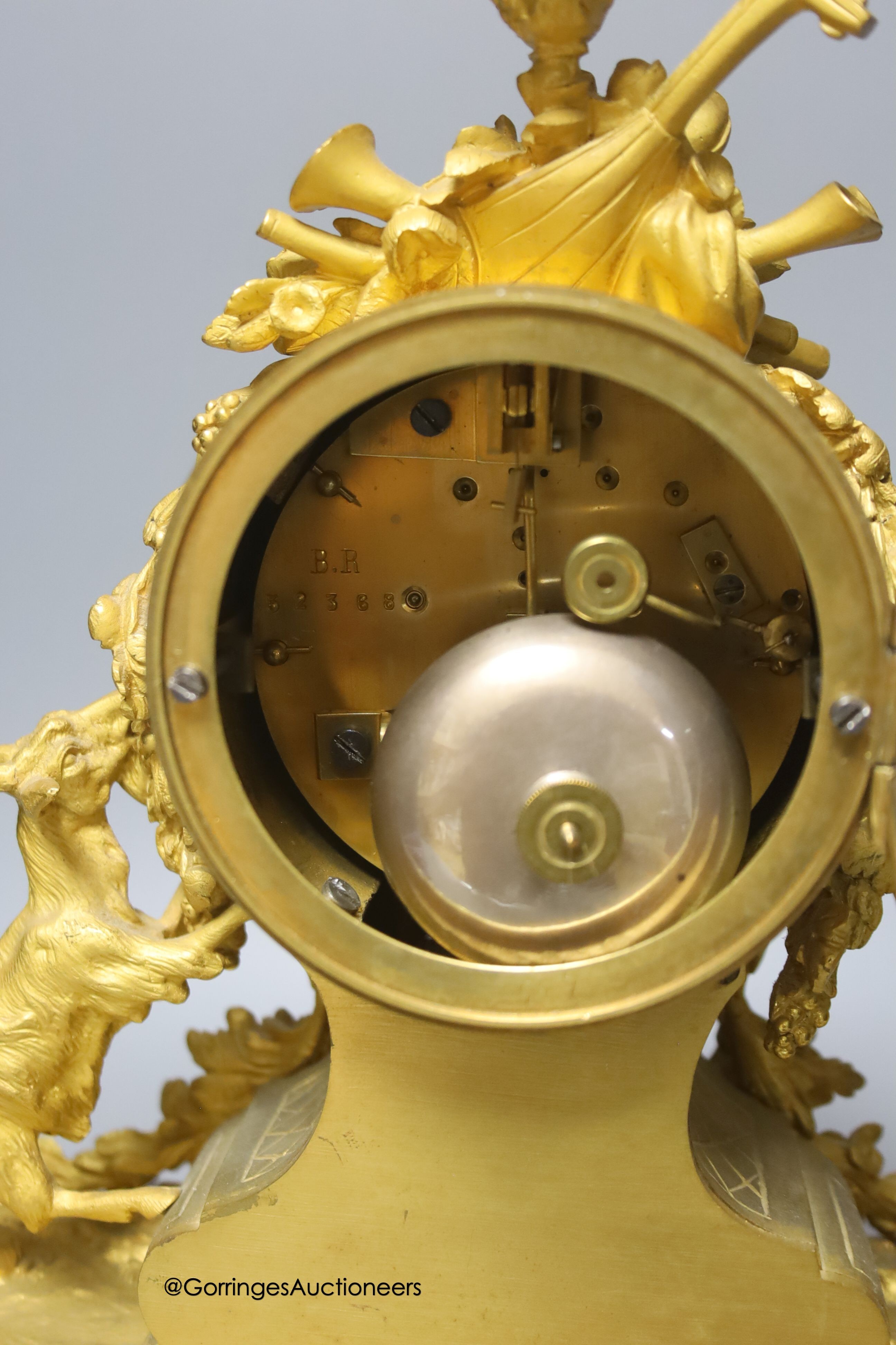 A 19th century French ormolu and porcelain mantel clock, with key and pendulum, overall height 33cm